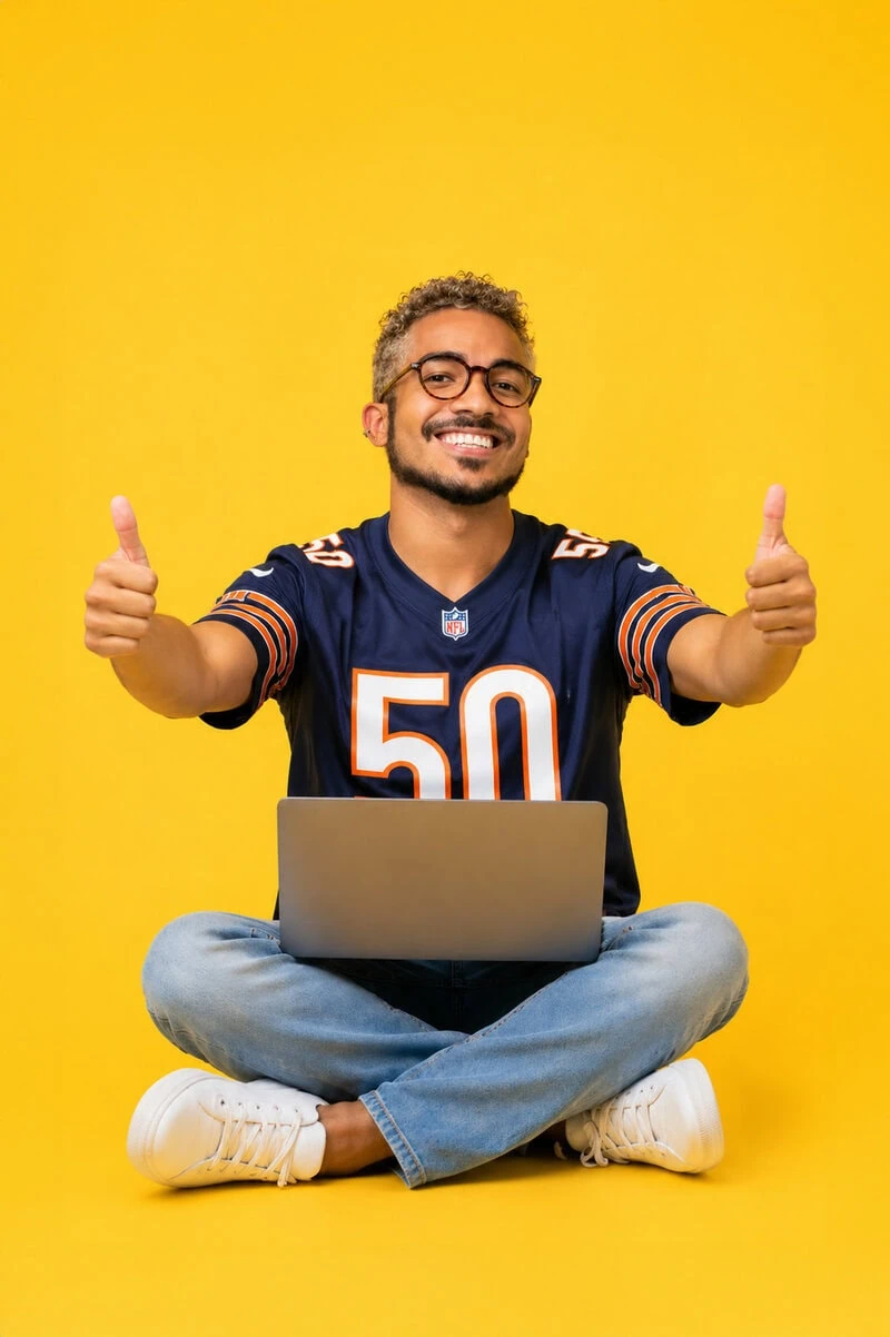 **Alt text** Man using a laptop and giving thumbs up, representing on-site SEO and website optimization success